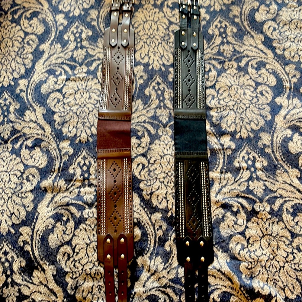2 belts, one black, one brown. Both leather, very cute double buckles, small/med